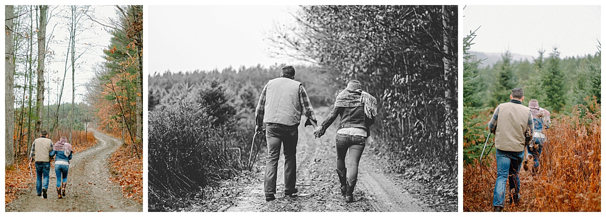Couple walking arm in arm down a rustic forest trail during their Christmas tree farm photo session in Horseheads, NY